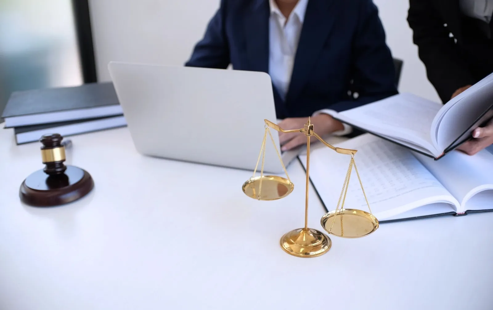 Law firm bookkeeping with laptop, legal documents and scales of justice